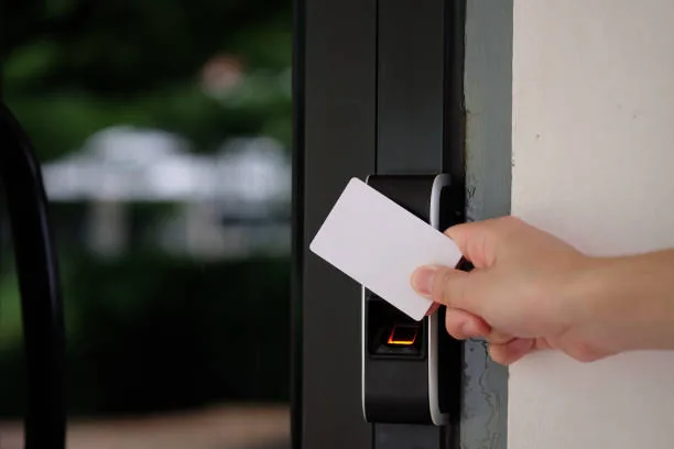 A staff card held against a door reader